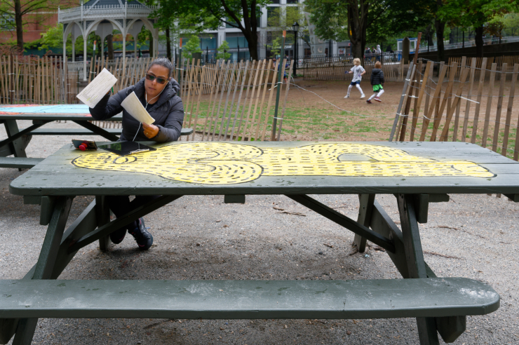 Lida Quintana, a medical student and nanny to three children, studies biochemistry, with Frank Ape looking on. “It’s beautiful,” she said of the new art. “And my kids love it.” Photo: Carl Glassman/Tribeca Trib
